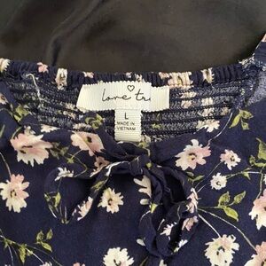 This is an off the shoulders top. It is very cute and festive.